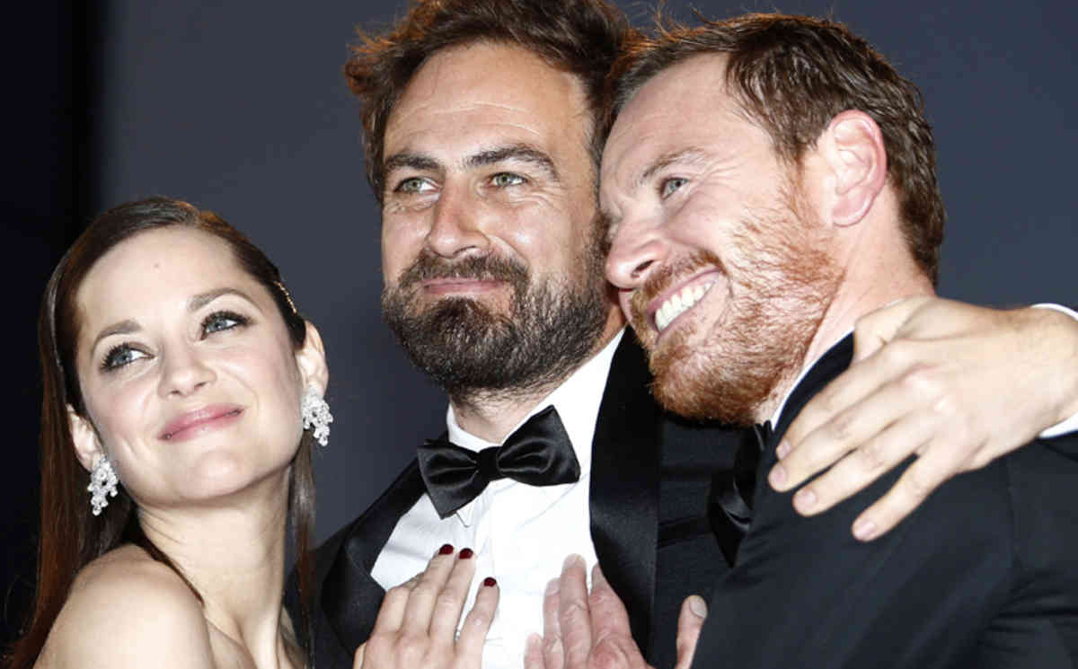 epa04764216 (L-R) French actress Marion Cotillard, Australian director Justin Kurzel and Irish-German actor Michael Fassbender leave the screening of 'Macbeth' during the 68th annual Cannes Film Festival, in Cannes, France, 23 May 2015. The movie was presented in the Official Competition of the festival which runs from 13 to 24 May.  EPA/IAN LANGSDON