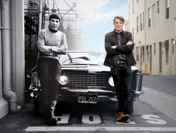 Adam Nimoy (right) re-creates his father (Leonard Nimoy)’s iconic pose with the family Buick Riviera. Leonard was photographed in 1966 while shooting Star Trek: The Original Series at Paramount Studios, while Adam traced his father’s footsteps on the same lot in 2015 during the production of For The Love Of Spock. (Archive photo courtesy Nimoy Archive / CBS, Modern photo & artwork courtesy Kai de Mello / 455 Films)